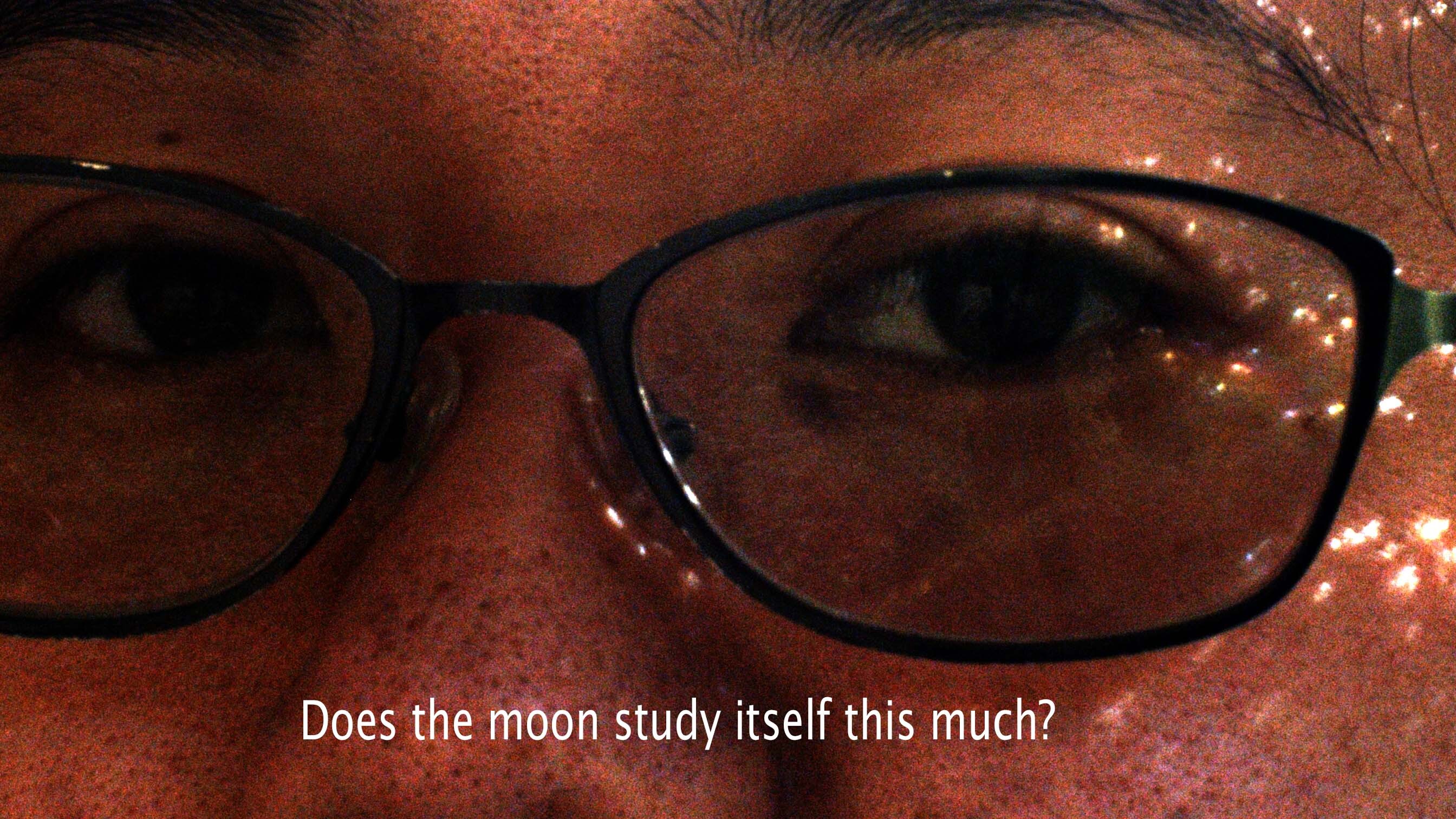 renee eyes behind glasses with caption reading: Does the moon study itself this much?